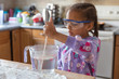 © absphotography/Stocksy - Portrait of a young female child mixing a solution for a science experiment