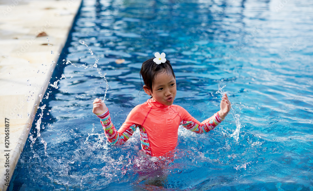 Cute asian little girl playing in the pool Stock Photo | Adobe Stock