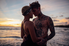 Young Couple Embracing On Beach