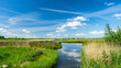 Beautiful polder landscape with the reflections of the sky in a wide ditch, near Rotterdam, the Netherlands