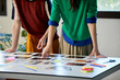© ALTO IMAGES/Stocksy - Colleagues Choosing Photographs At Desk In Office