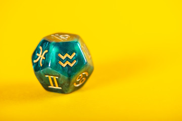 Astrology Dice with zodiac symbol of Aquarius Jan 20 - Feb 18 on Yellow Background