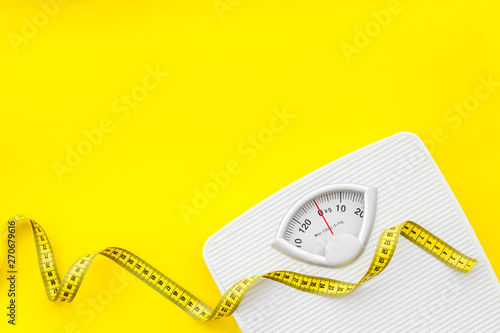 Download Slim Concept With Scale And Measuring Tape On Yellow Background Top View Mockup Stock Photo Adobe Stock