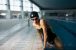 © Branko Starcevic/Stocksy - Professional young swimmer jumping out of the swimming pool.