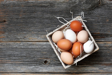 Fresh farm eggs on  wooden rustic background