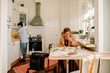 © Maskot - Retired senior woman eating breakfast while female caregiver working kitchen at nursing home