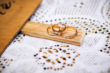 wedding rings with beautiful carvings on the sand background