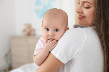 Sticker - Mother holding her adorable baby at home. Space for text