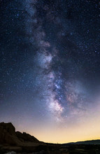 Scenic View Of The Starry Night Sky Showing The Milky Way Galaxy Depicting Astronomy Science Or A Religious View Of Heaven.  The Landscape Is Taken At Nighttime.