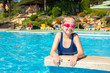 © lizaelesina - Happy little girl in goggles playing in swimming pool Beach resort, summer vacation, travel and tourism concept