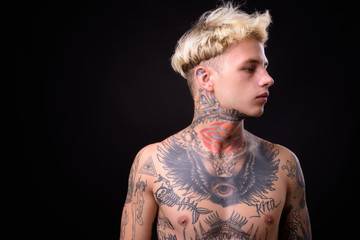 Wall Mural - Young handsome rebellious man with tattoos shirtless