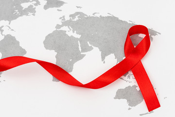 Wall Mural - Aids Awareness Red heart Ribbon on world map .