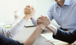 © StockPhotoPro - Business people arm wrestling in the office