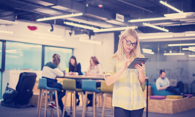 Poster - blonde businesswoman working online using digital tablet