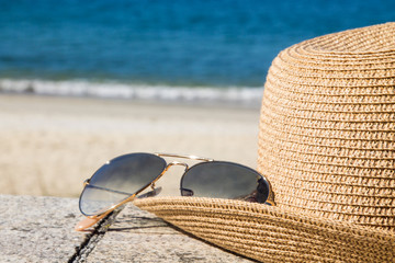 hat and sunglasses in the landscape of the beach, holidays and summer