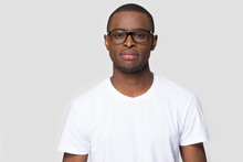 Serious African Male Wearing Glasses White T-shirt Posing Indoors
