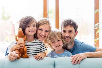 Wall Mural - Happy young family with two children at home