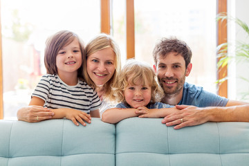 Wall Mural - Happy young family with two children at home