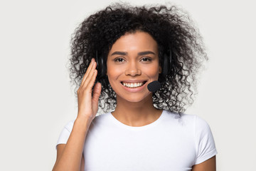 Mixed race female wearing headset smiling looking at camera