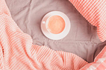 Wall Mural - Bed with pink knitted plaid and coffee