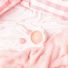 Wall Mural - Bed with pink knitted plaid, coffee and macaroons.