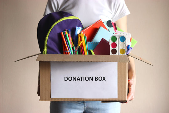 girl holding a box with donations