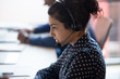 © fizkes - Serious indian female agent in headphones consult client