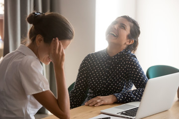 Smiling women have fun laughing at break at workplace