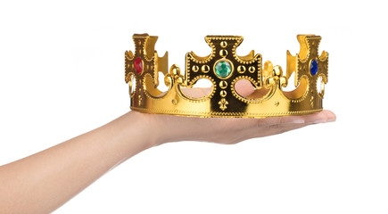 Wall Mural - Hand holding crown golden isolated on a white background