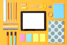 Modern Digital Tablet And School Stationery On A Colored Background Top View. Kontpt Back To School. Place For Text.
