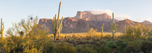 A Panorama Image Of The Superstition Mountains In Arizona In The Morning Light.  The Image Contains Saguaro Cactus And Dramatic Clouds On The Peaks.