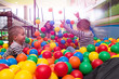 © .shock - young mom playing with kids in pool with colorful balls