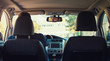 © 1STunningART - Confident and patient man driving his new car with calm face emotion reflected in the back view mirror. Experienced driver keeps hands on the steering wheel