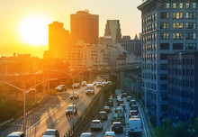 View Of Rush Hour Traffic On The Brooklyn Queens Expressway In New York City With Sunset Background