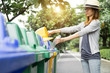 Waste management, Woman throwing plastic bottle into recycle bin. Waste separation rubbish before drop to garbage bin to save the world, environment care. Pollution trash recycling management concept.