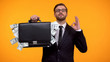 © motortion - Male showing briefcase with money and doing ok gesture, payday lending service