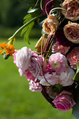 Wall Mural - summer bouquet of different flowers on a blurred green background