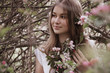© Iveta - young woman in white dress stay in apple garden and smile