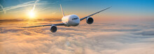 Commercial Airplane Jetliner Flying Above Dramatic Clouds In Beautiful Light. Travel Concept.