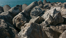 Breakwater Made Of Boulders, Rocks And Moulded Concrete On Atlantic Coast Of Portugal