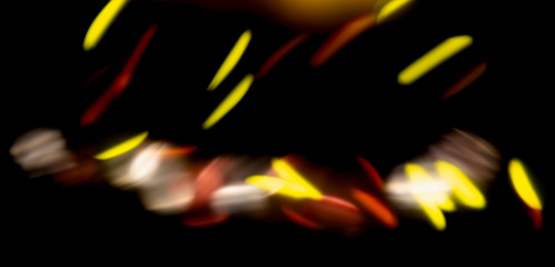 Wall Mural - bokeh textures on black background of different colors from amusement Park with motion simulation