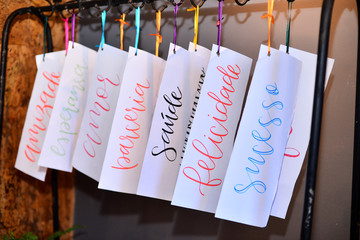 pieces of paper with positive words, paper cutouts hanging, cards