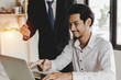 © Vittaya_25 - business man feeling excited with raised up hands expressing positive successful to young man employee in meeting room at home office company, investment, financial, encouragement and teamwork concept