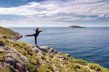 Wall Mural - Young woman dancing and enjoying beautiful view. Kalymnos Island, Greece.