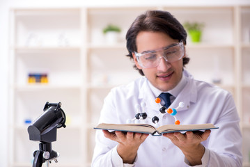 Wall Mural - Young male scientist working in the lab 