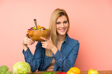 Young blonde woman with salad