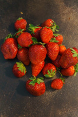 Wall Mural - Fresh whole strawberries on a dark table.