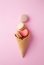 Macarons In A Ice Cream Cone On A Pink Background Viewed From Above. Top View