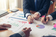 © amnaj - Business people meeting together about investment and the discussion graph financial information at the meeting.