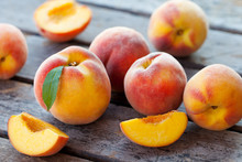 Fresh Peaches, Fruits On Grey Wooden Background. Close Up.
